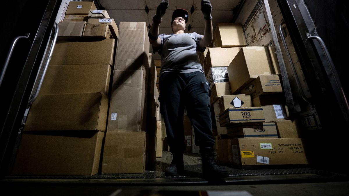 Lana Provost, a UPS package handler, loads packages into a truck at the UPS Centennial Ground Hub on December 6, 2021 in Louisville, Kentucky.