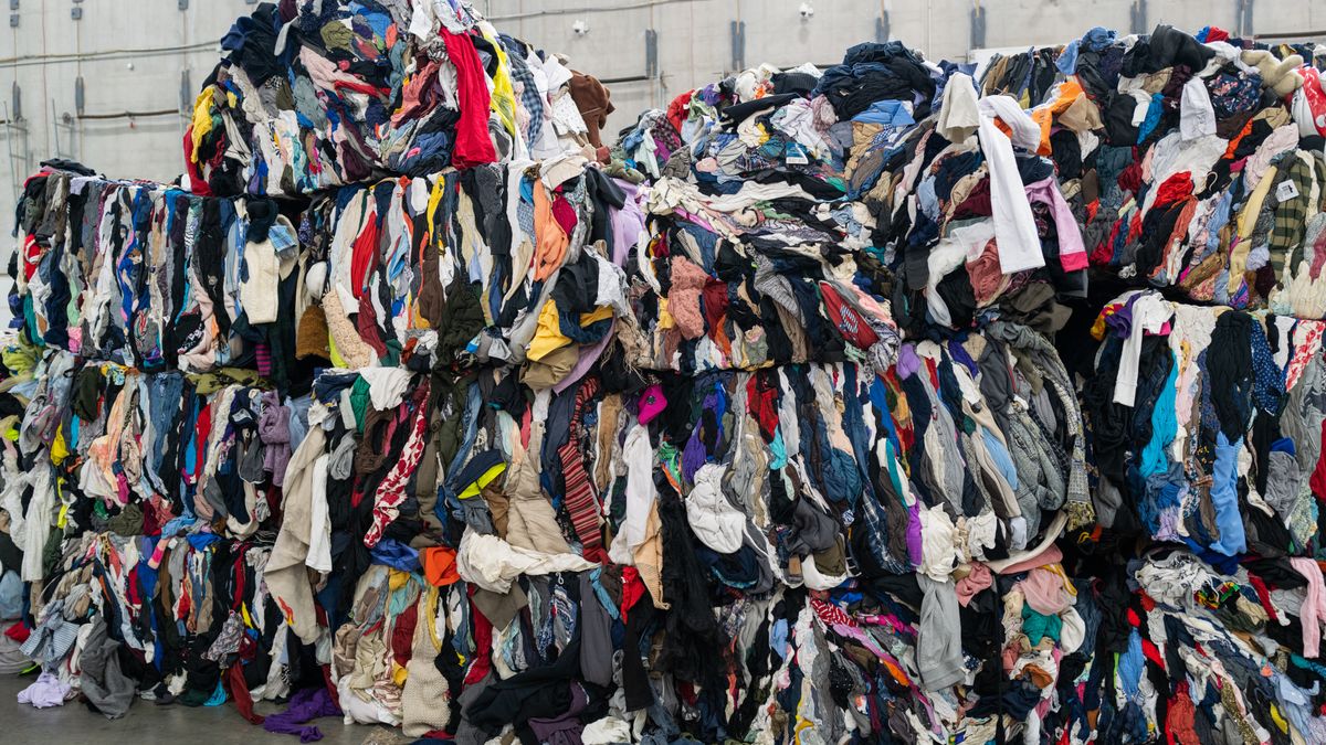 Piles of unsold multi-colored clothing in a large heap