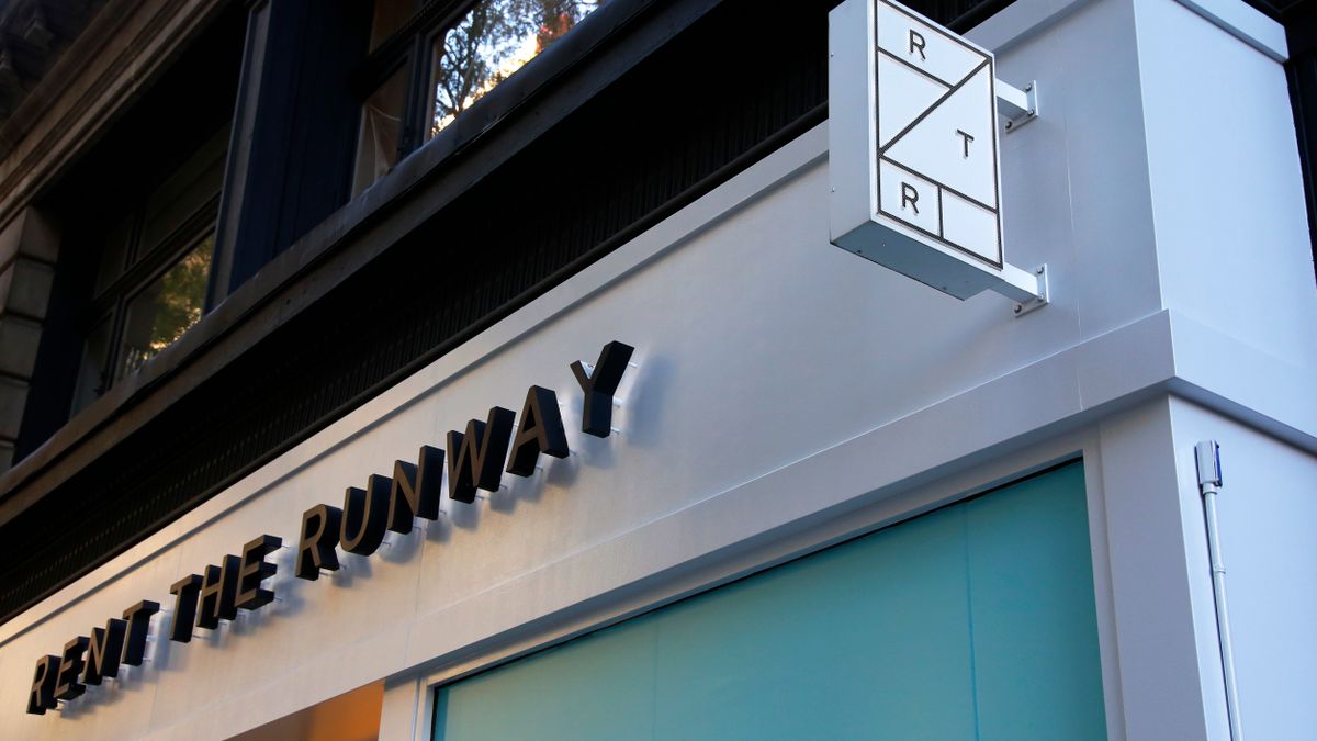the top corner of a Rent the Runway store is seen from outside on a sunny day.