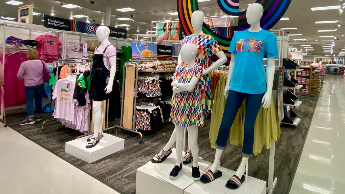 Store mannequins in a colorful merchandising display featuring apparel.