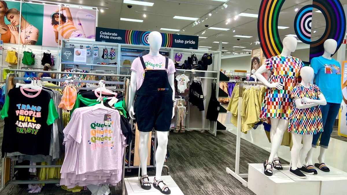 Mannequins and clothing racks in a store's display for Pride Month.