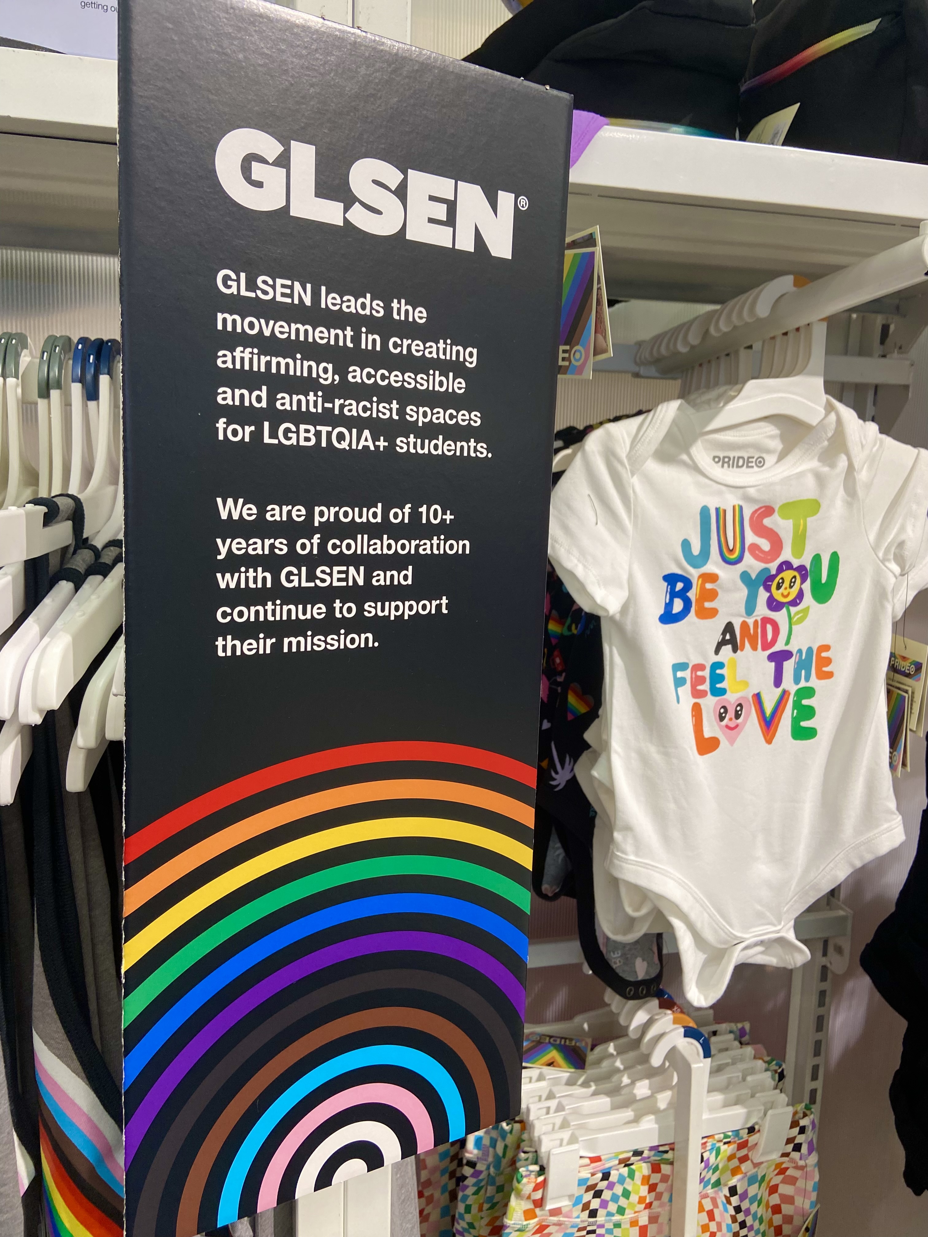 A sign posted on a rack of apparel for children promotes GLSEN, which "leads the movement in creating affirming, accessible and anti-racist spaces for LGBTQIA+ students.
