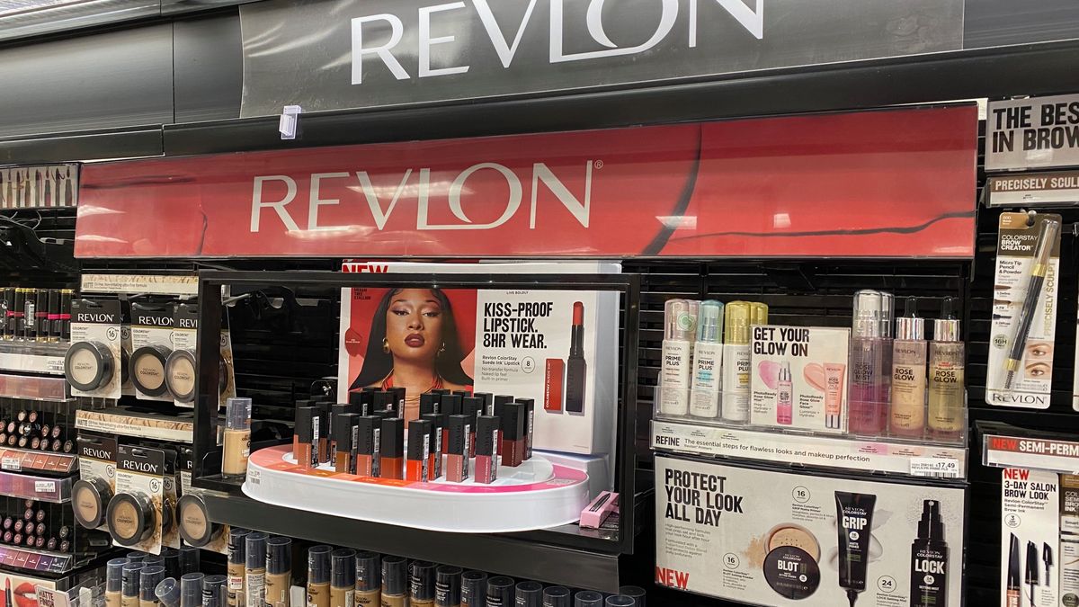 Line up of Revlon products inside of a store with the Revlon sign.